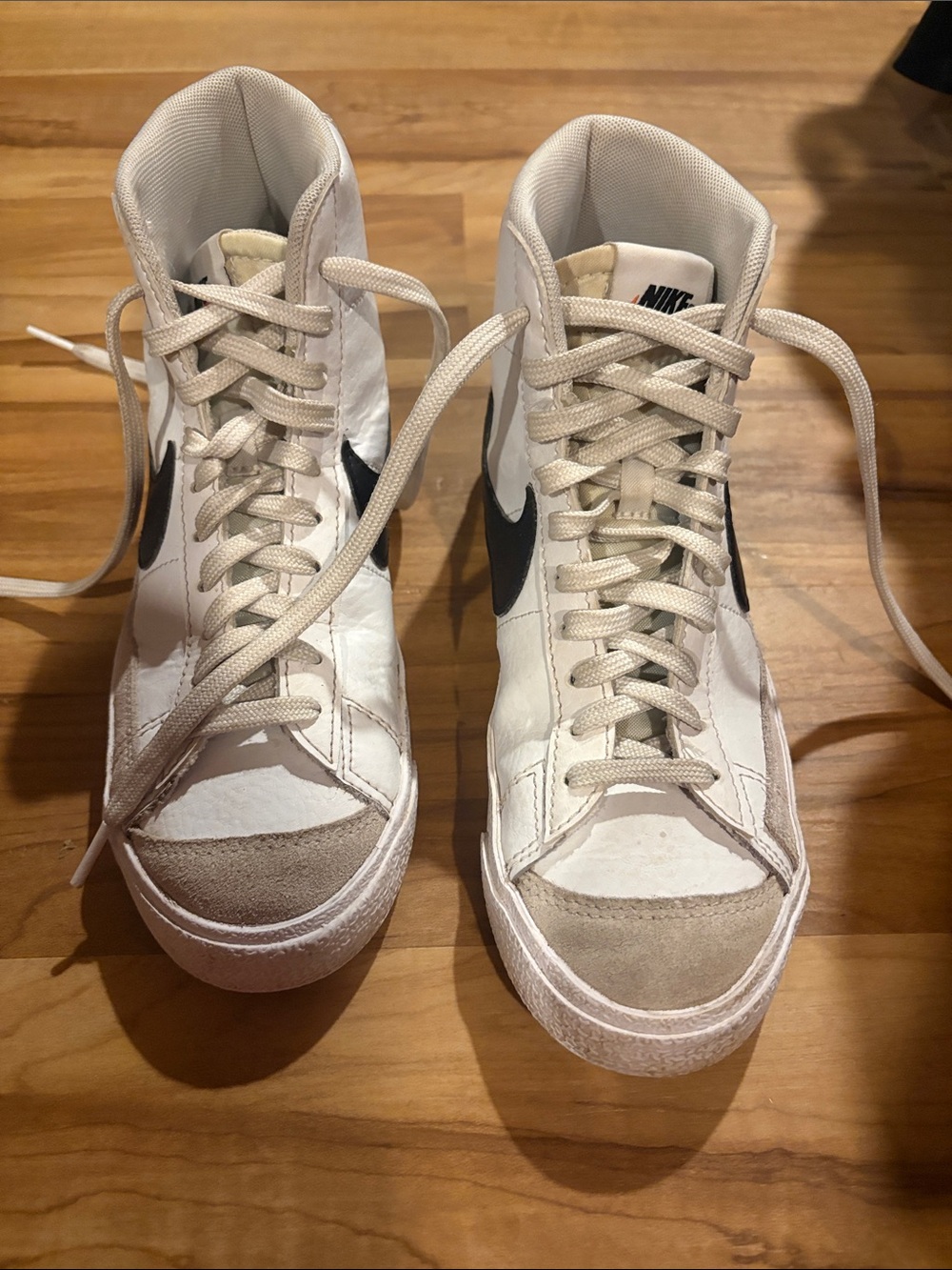 Nike Women's High-Top Sneakers in White with Black Swoosh